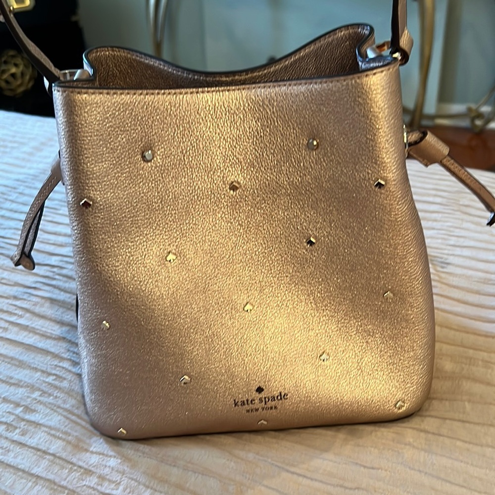 Beautiful barely used Kate Spade bucket pinkish gold with gold spade accents bag